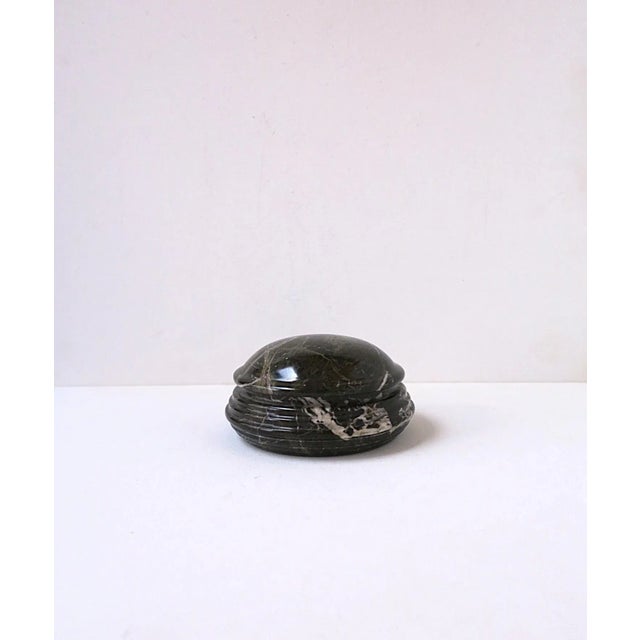 A round marble box, Postmodern design period, circa late-20th century. Marble is a dark moss green with white veining. A...