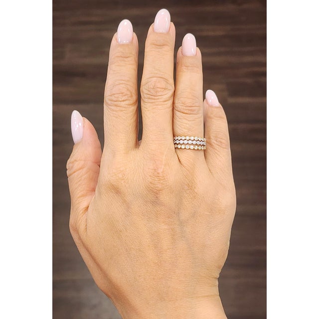 This elegant three-piece diamond band set showcases a beautiful combination of yellow, white, and rose gold, creating a...