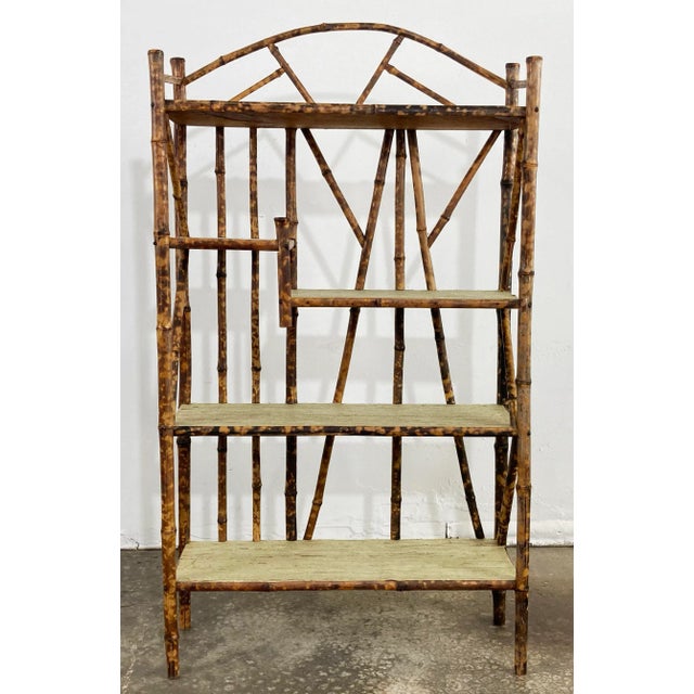 Stunning and substantial five tier wood and bamboo bookshelf featuring a Chinoiserie style look with a scorched bamboo...