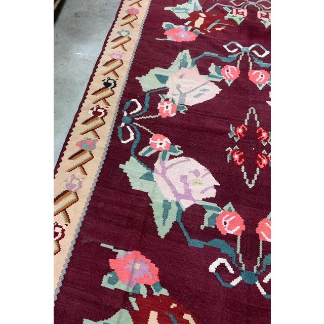 Handmade vintage Bessarabian kilim from Romania and burgundy and beige shades. The rug is from the middle of 20th century...