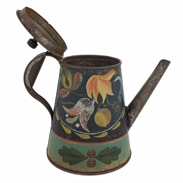This large Pennsylvania German tinware coffee pot is a beautiful example of American folk art, showcasing primitive...