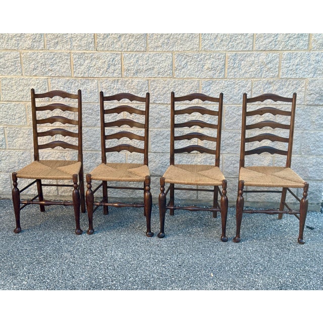 Solid wood ladderback dining chairs with handwoven rush seats and turned front legs. Classic French Provincial form with...