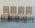 Solid wood ladderback dining chairs with handwoven rush seats and turned front legs. Classic French Provincial form with...