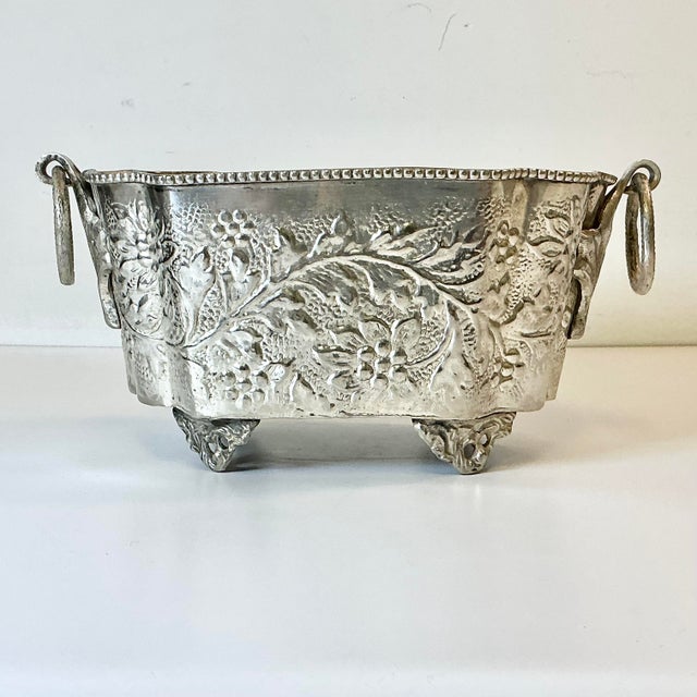 Vintage Home is pleased to present this Antique hand wrought hammered silverplated planter. It was curated from an estate...