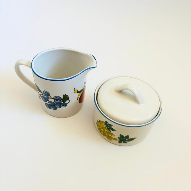 A vintage stoneware cream and sugar set. From the "Essence" collection by Tabletops Unlimited. Pale gray glaze with blue...