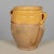 An earthenware confit pot from the Southwest of France with traditional yellow glaze and a drip of green on one side....