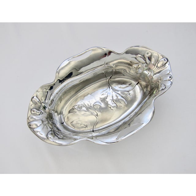 A European Art Nouveau bowl of oval form with a reflective, silvery surface of highly-polished pewter from Osiris of...