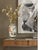 This large ceramic statement vase stands 13 1/2 inches tall and measures eight inches at its widest point, presenting a...