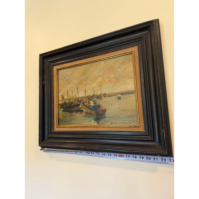 Oil on canvas painting, titles Fishing Boats. The composition captures a peaceful harbor where a cluster of fishing boats...
