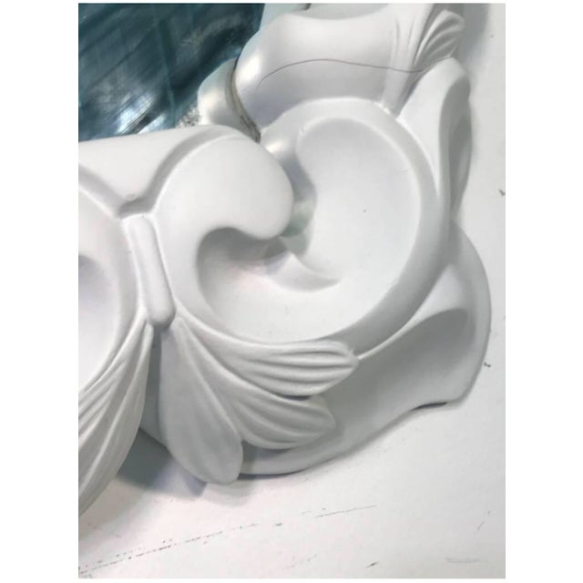 White plaster mirror in the manner of Serge Roche, 1970's. Glamorous frond frame. In good condition. Measures 25" high by...