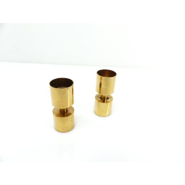 Pair of solid brass candlesticks produced in Sweden in 1976 to celebrate the centenary of the Zoégas coffee house...