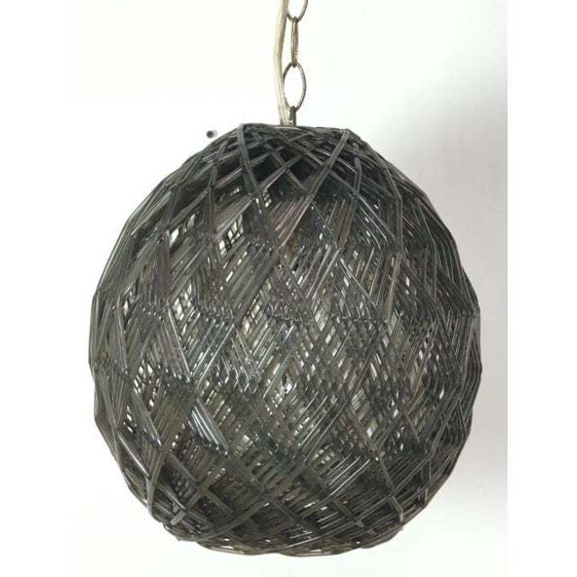 An exceptional vintage 1970s Space Age geometric swag pendant light. Expertly crafted with a complex, overlapping woven...