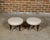 A pair of English mahogany stools from the 19th century with turned legs resting on casters and upholstered seats. This...