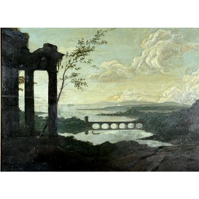 An 18th Century British oil on panel Italianate landscape of extensive valley with classical ruins. Unsigned. The painting...