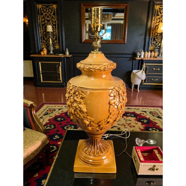 The Vintage Neoclassical Urn Swag Bradburn Gallery Table Lamp is a unique and elegant lighting piece with a touch of...