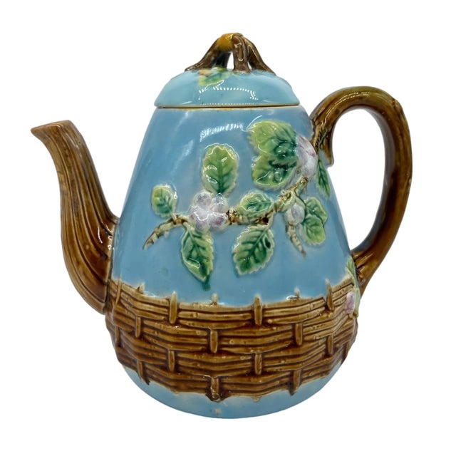 George Jones Majolica 'Apple Blossom' Teapot, the pear-shaped teapot and lid molded with blooming apple tree limbs, with a...