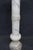 Elegant Italian carved white marble pedestal featuring a spiral twist column accented by a carved Greek key band and a...