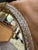 Elegant round wall mirror featuring a clear Murano glass frame with a textured, rope-like pattern. Four broad brass mounts...