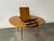 A Mid-Century extending dining table with formica top. Made by Schreiber furniture, this vintage table has a warm golden-...