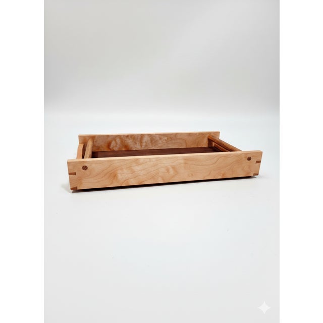 Mocha is a sculptural, limited-edition tray where figured maple, walnut, and African teak converge. Eschewing industrial...