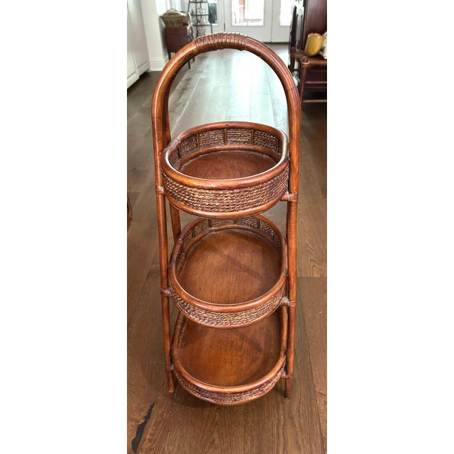 Unusual piece with an endless number of uses. Rich brown rattan and bent wood stand with 3 storage bins that can display...