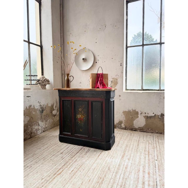 Antique 1920s shop counter with its original black patina and floral paintwork. we love its compact size and shallow...