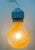 Blown glass pendant in the shape of a light bulb with single-color orange murrine hand-rolled by master glassmakers,...