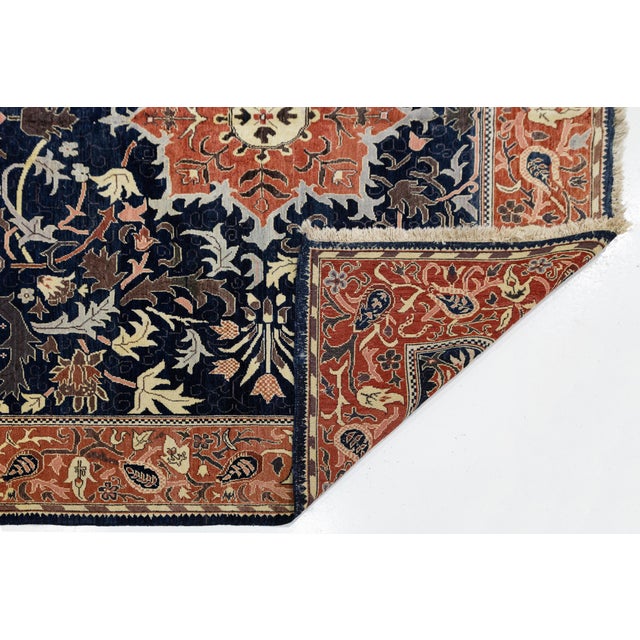 Enhance your space with this vintage Sultanabad style rug. Hand-knotted from high-quality wool, it features a navy blue...
