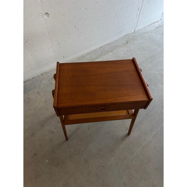 A beautiful mid-century teak nightstand from the 1960s, attributed to the Swedish manufacturer AB Carlstrom. The table has...