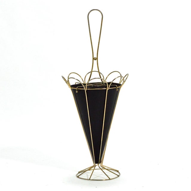 This delightful umbrella stand in brass rod and painted steel is in the form of an abstract umbrella. It is pretty when it...