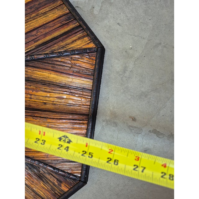 This is a vintage 1970s mid-century bohemian style octagonal wall mirror featuring an intricately crafted frame made of...