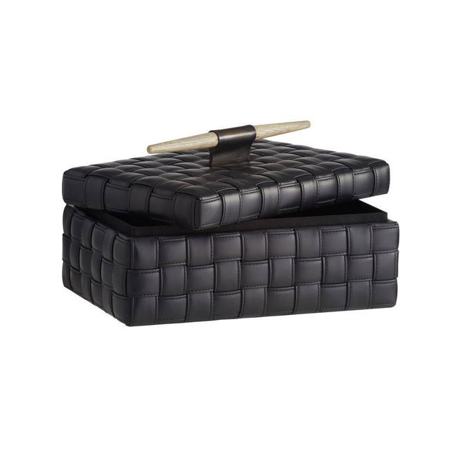 Our Humphrey Box is wrapped in a basketweave pattern of topstitched black leather. Accented with a spear-shaped handle of...