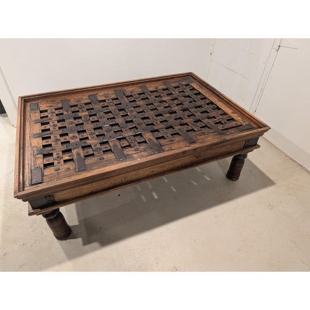 A striking example of architectural salvage furniture, this large coffee table was built around a repurposed Indian...