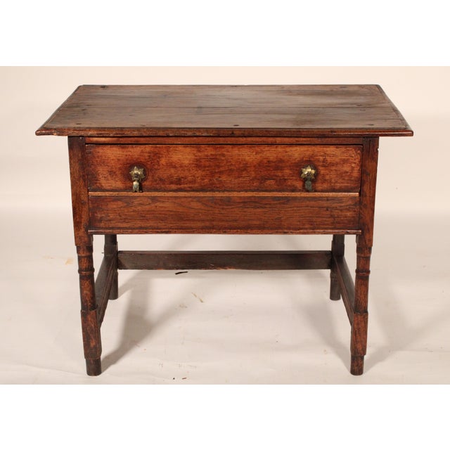 Antique William and Mary style oak side table, 19th century. With a two board top with molded front back and side edges, a...
