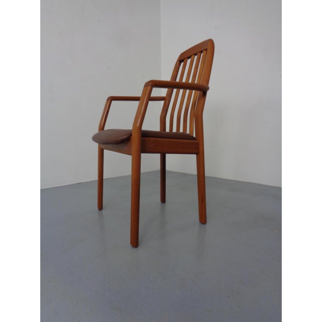 Armchair by Dyrlund in solid teak. Seat upholstered in brown leather. This piece has an attribution mark, I am sure that...