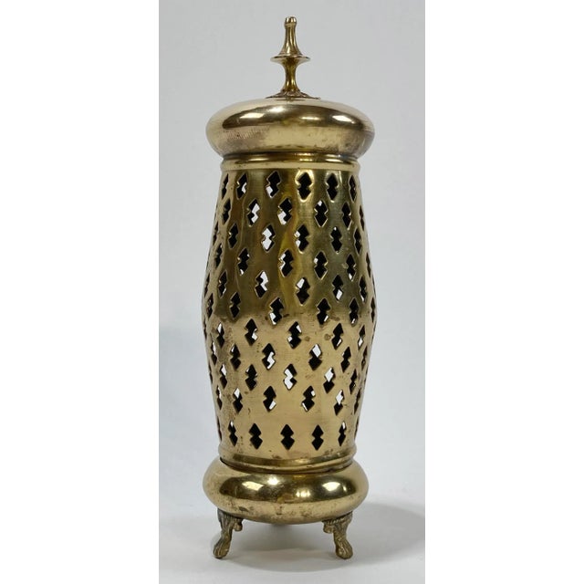 Vintage lidded brass filigree style lantern. Holds single taper candlestick. Strong patina, especially to one side of lid...