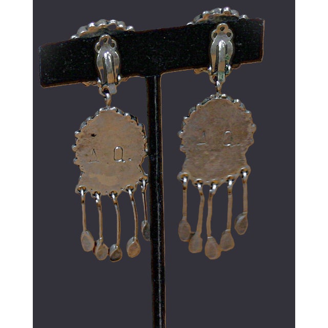 An incredible pair of Zuni dangle earrings by well known and collected artist, Alice Quam. She has used gorgeous coral...