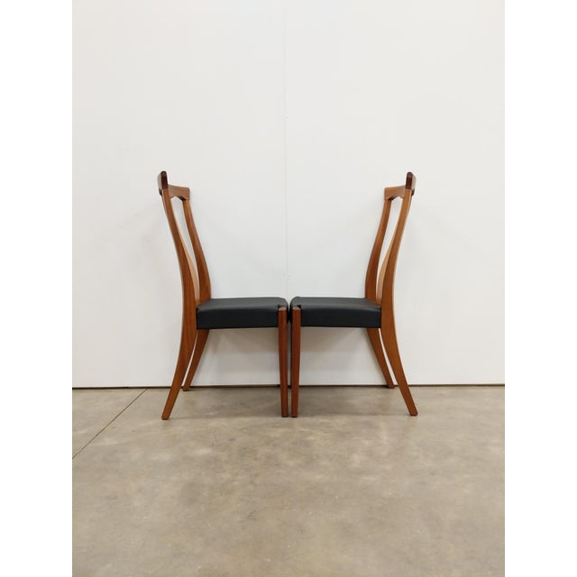 Pair of authentic vintage mid century modern dining chairs. This set is in excellent condition with brand new black vegan...