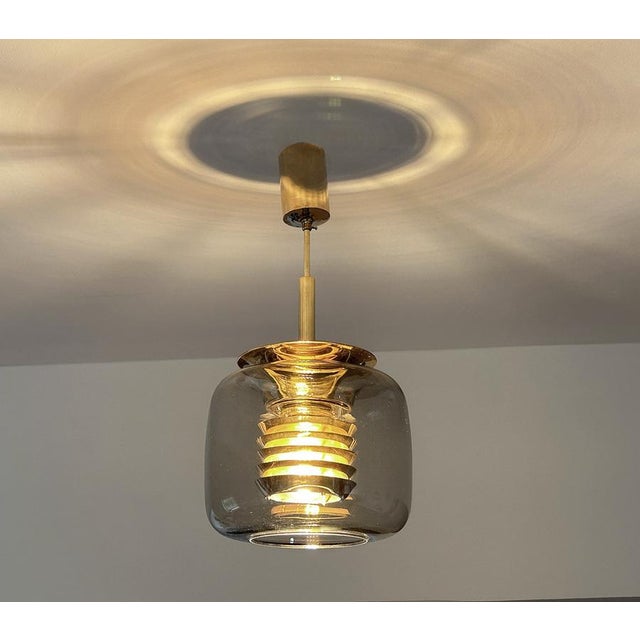 Mid-century gilded pendant light by ecor, model 52 276, design in the manner of jacobsson, featuring a flattened light...