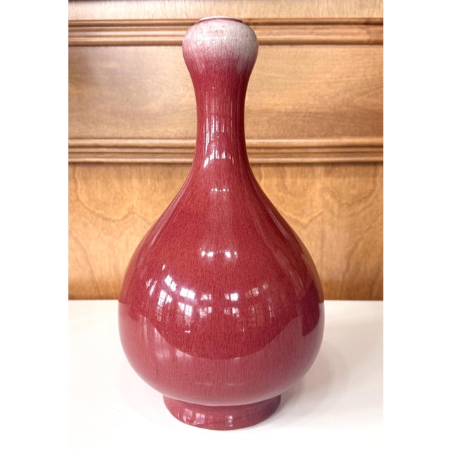 A tall Chinese vase with Sang-de-Boeuf (oxblood) glaze in a Shuantou (Garlic Head) form circa 18th century from Qing...