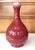 A tall Chinese vase with Sang-de-Boeuf (oxblood) glaze in a Shuantou (Garlic Head) form circa 18th century from Qing...