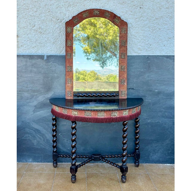 The mirror, with its arched top and decorative detailing, with measurements: Height 94 cm, Width 65 cm, Depth 3,5 cm,...