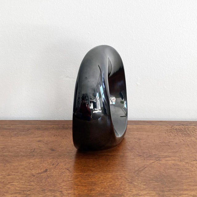 A stunning rare abstract Haeger gloss black ceramic twisted orb sculpture. This piece solicits interest from all angles,...