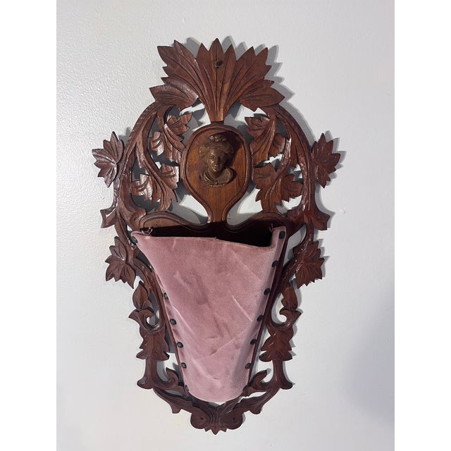A beautifully hand-carved antique Black Forest-style wall pocket dating to the early 20th century. Crafted from richly...