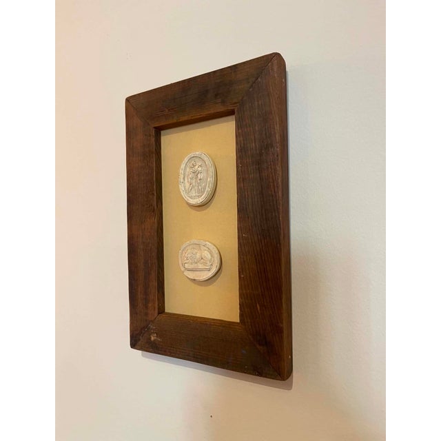 Immerse yourself in the enduring allure of classical antiquity with this truly unique collection of framed intaglios....