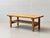 A simple coffee table made of solid oak with a clean, functional design in the style of scandinavian mid-century modern....