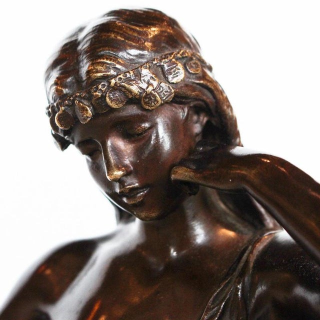 Captive, an Art Nouveau rich brown patinated bronze figure of a scantily clad young lady. Signed Hip Moreau to cast, and...