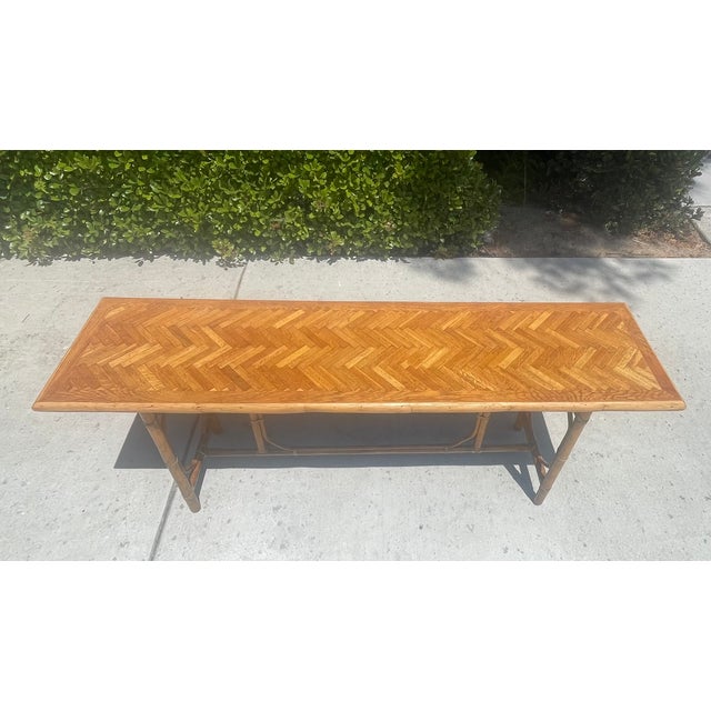 Gorgeous vintage console table by luxury furniture maker, McGuire of San Francisco. Featuring over 6’ of boho style with a...