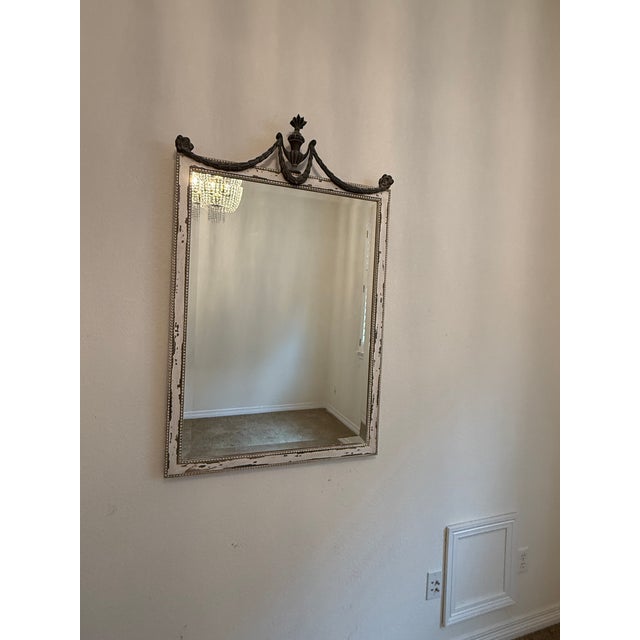 This beautiful Ethan Allen wall mirror is framed in distressed wood and an antique white and gray finish with a...