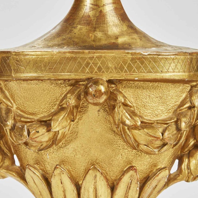 A late 18th-century gilded Empire wall lamp, crafted from a carved and finely gilded wooden palm-holder vase, converted...